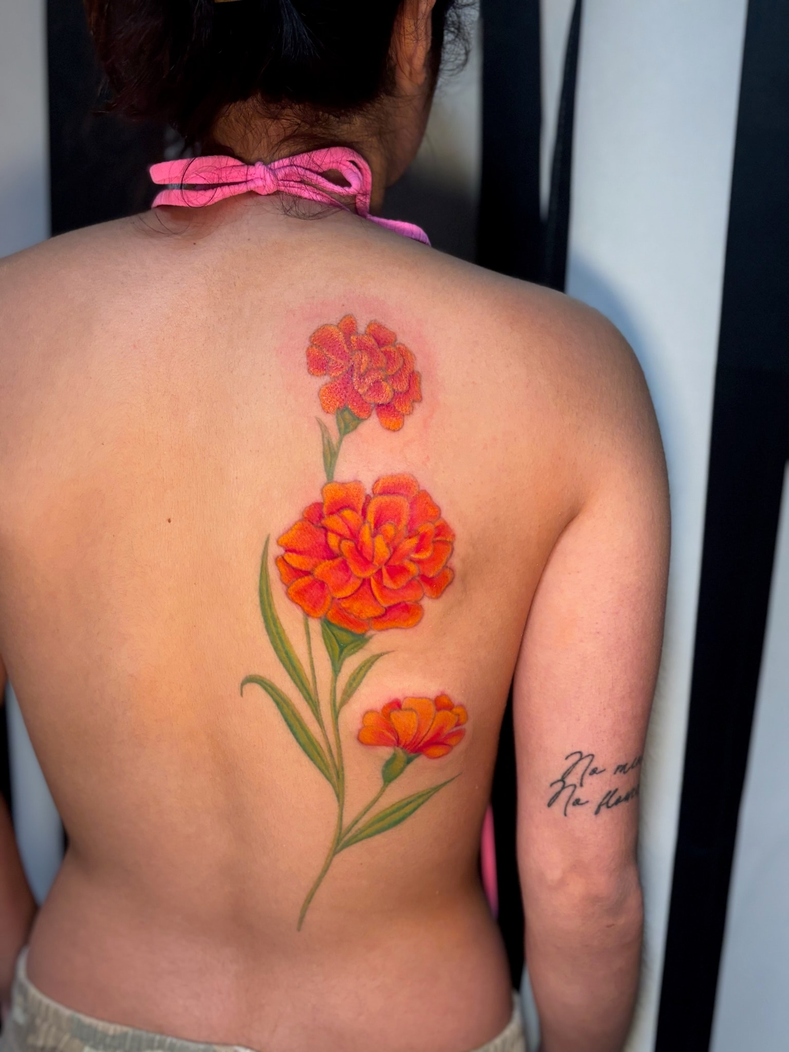 Red carnation flowers back tattoo, neo-traditional color