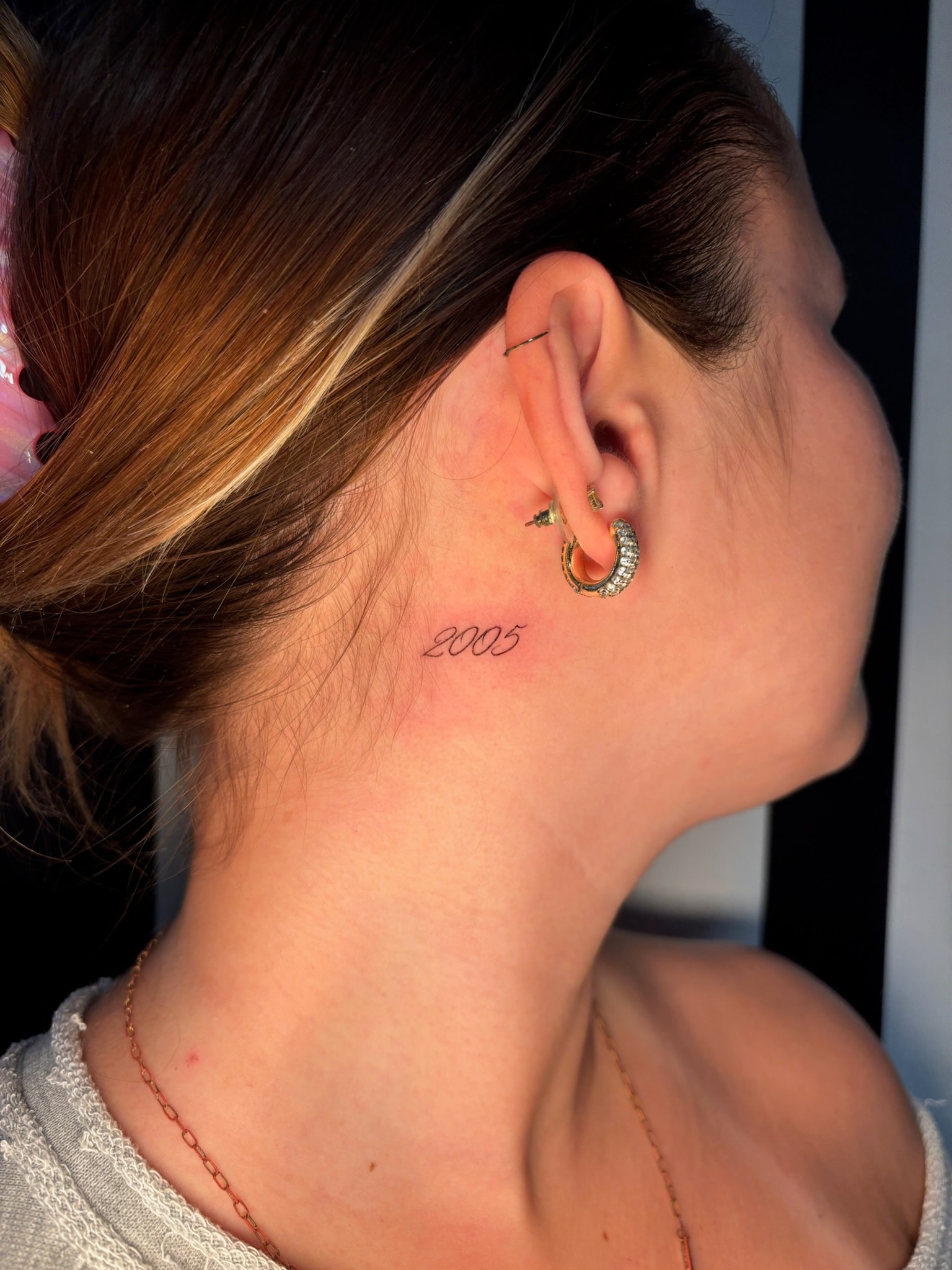 Fine line script 2005 tattoo behind ear on neck