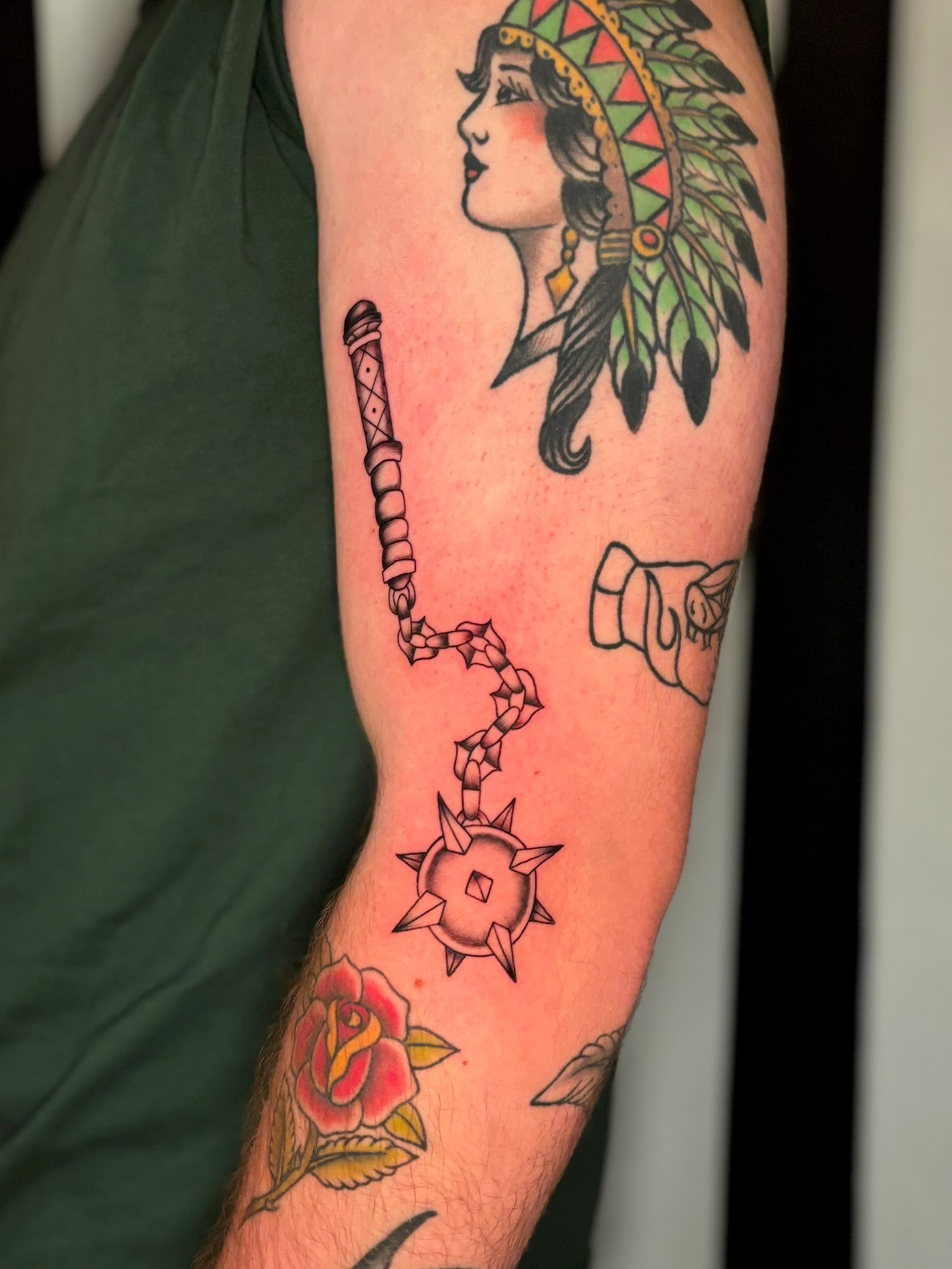 Traditional tattoo sleeve with Native American portrait, flail mace, rose, and fist