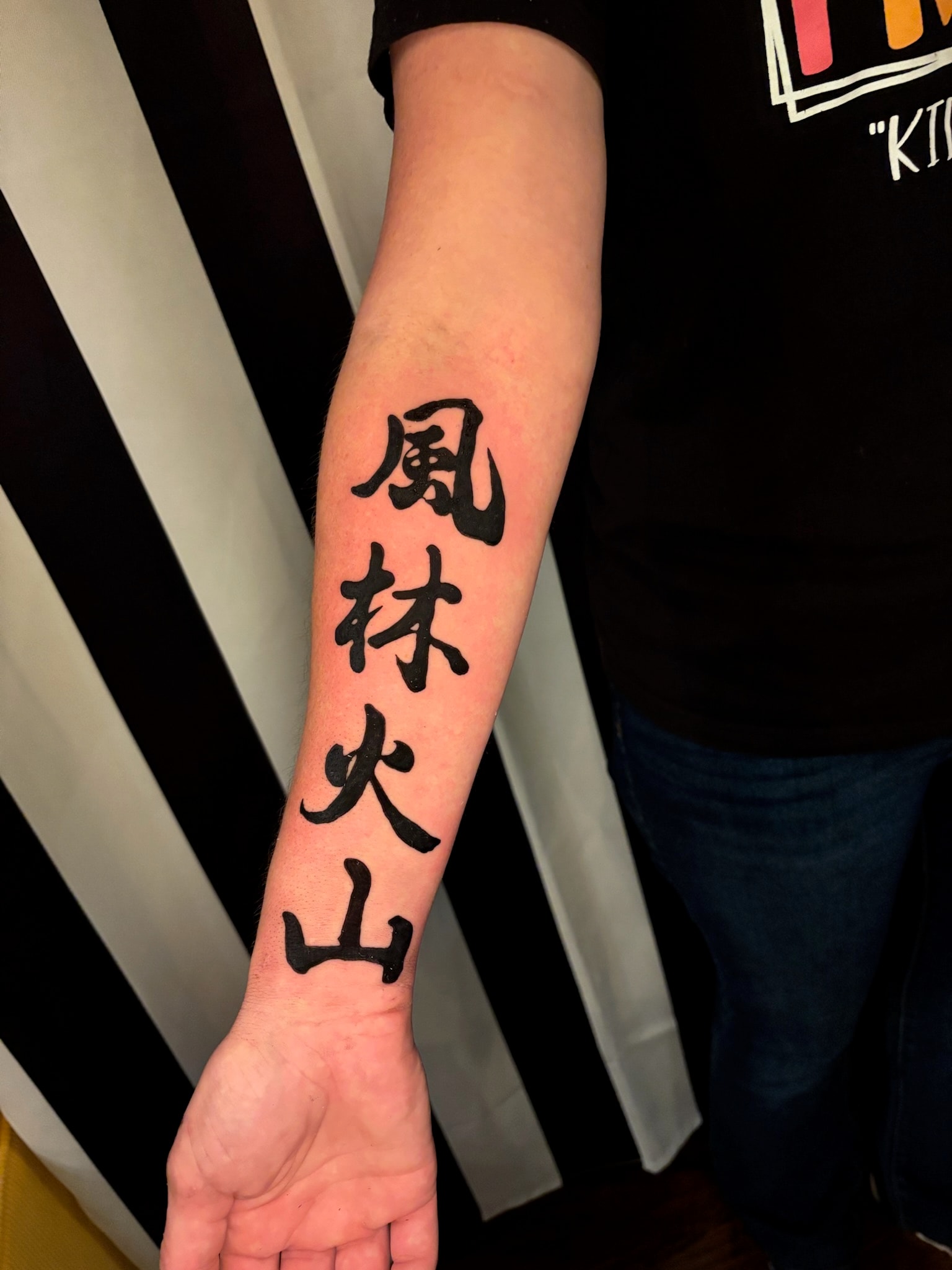 Chinese characters script tattoo on forearm, fine line